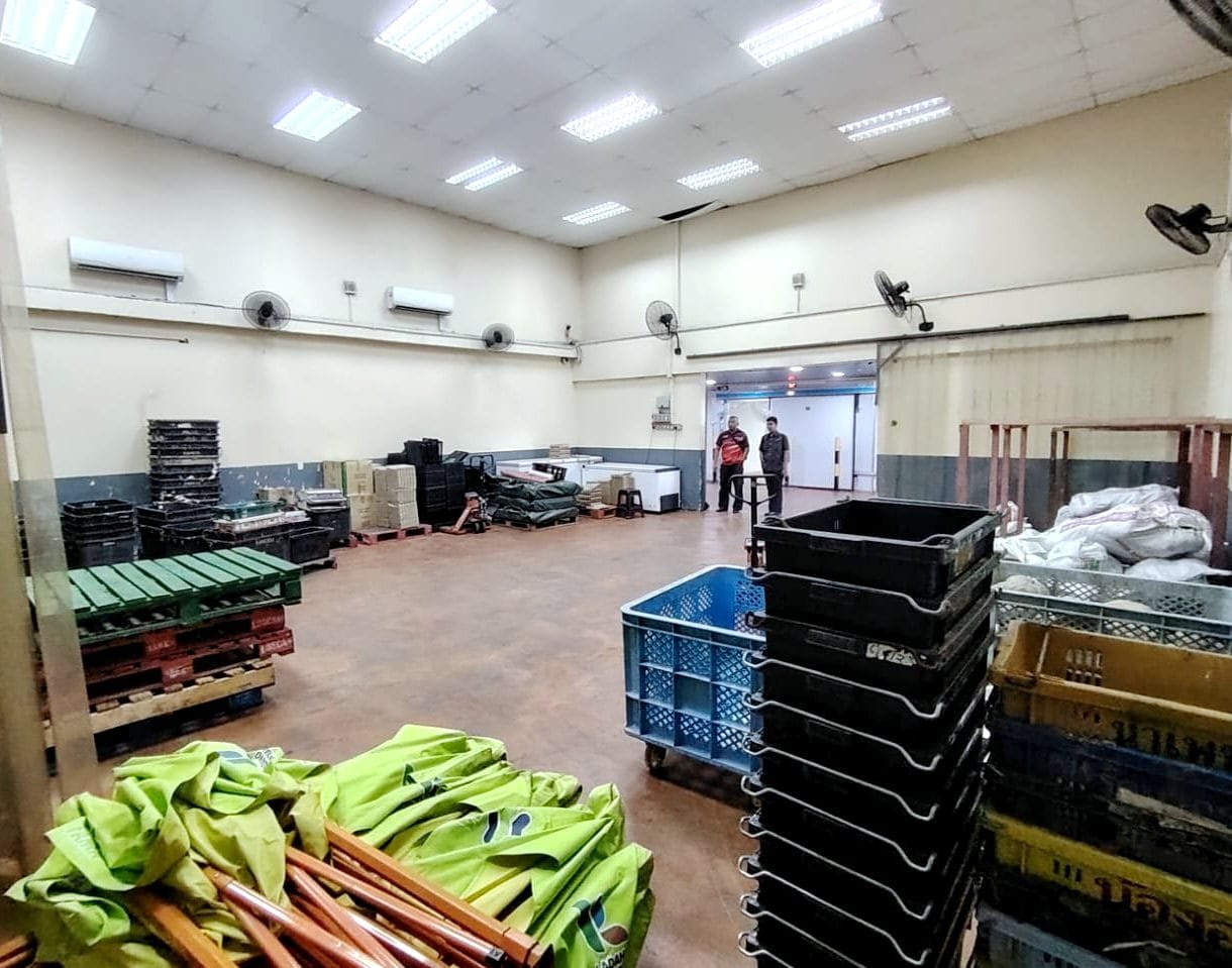 Luxamana warehouse hall with pallets, crates and staff working the floor